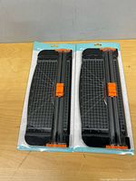 Two packaged paper cutters front view