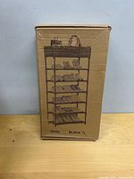 Closed cardboard box with product illustration of six-tier shoe rack