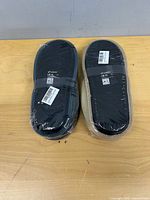 Two sealed pairs of Coface men’s slippers soles visible