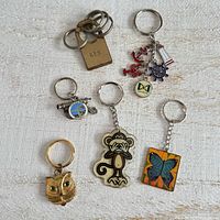 Overview of all seven key chains on white surface