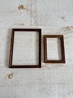 Both wooden frames side by side on white surface