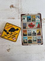 Front of both metal signs showing designs