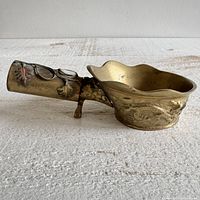 Side view showing dragon motif bowl and decorated handle