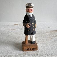 Front view of carved peg-leg captain figurine with Cape Cod base inscription
