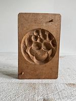 Front view of carved wooden Kashigata mold showing floral motif and overall wear