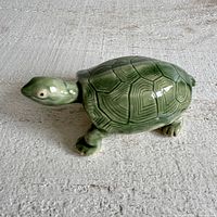 Side profile of green ceramic turtle figurine