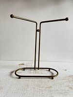 Front view of brass-tone metal towel rack stand
