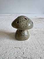 Front view of ceramic mushroom flower frog showing cap holes and glaze pattern