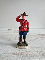 Front view of RCMP ceramic figurine showing uniform, base inscription and overall condition