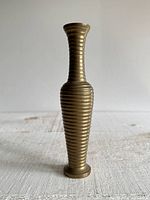 Full view of brass ringed vase standing upright