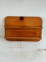 Front view of wooden two-shelf wall shelf