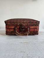 Front view showing hinged lid, double latches and handles