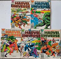 Front covers of five Marvel Universe Deluxe Edition comics laid out for condition view
