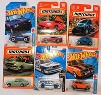 Six sealed Hot Wheels and Matchbox cars displayed front on cards