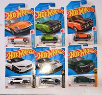 Front view of six Hot Wheels cars on cards