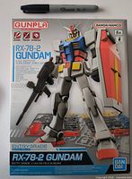 Front of box showing Bandai Entry Grade RX-78-2 Gundam 1/144 kit and scale reference marker