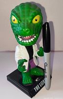 Front view of Funko The Lizard bobblehead with size reference marker