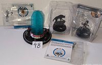 All four sealed WizKids HeroClix items with cards visible