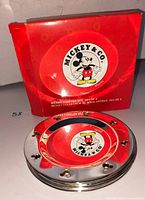 Box front and stacked metal Mickey Mouse coasters