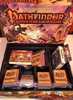 Open Pathfinder Adventure Card Game Rise of the Runelords box showing card decks, insert, rulebook and separate expansion deck