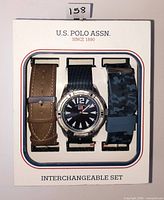 Boxed U.S. Polo Assn. watch with two extra straps visible