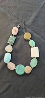 Necklace coiled showing varied gemstone slabs and clasp