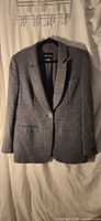 Front view of Giorgio Armani houndstooth wool blazer on hanger