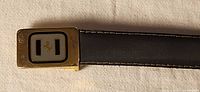 Gold-tone buckle with prancing horse logo and front leather view