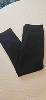 Front view of black ankle pants folded
