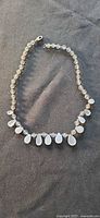 Full view of lucite bead necklace laid flat