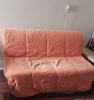 sofa mode front view of orange corduroy couch