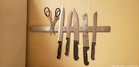Wall-mounted stainless steel magnetic utensil holder bar displayed with knives and scissors (knives not included)