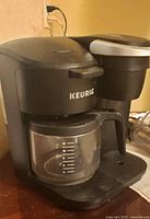 Front left view of Keurig dual coffee maker with carafe inserted