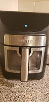 Front view of Gourmia air fryer showing windowed basket and handle