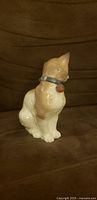 Porcelain cat with blue collar front view