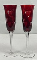 Pair of cranberry cut-to-clear wine glasses standing upright