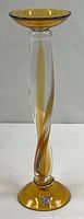Full view of amber and clear twisted-stem glass candlestick