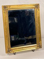 Front view of gold framed mirror