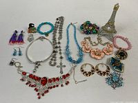 Full lot overview showing all jewelry pieces and Eiffel Tower