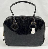 Front view of black snakeskin-embossed handbag