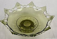 Top view of avocado green Ring & Petal footed bowl showing open lace rim and pedestal insert