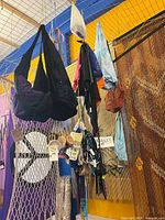 Assortment of handmade bags, headbands and pouches displayed hanging