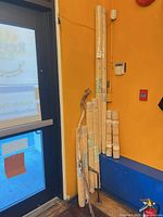 Corner view showing bundled bamboo blinds and walking stick