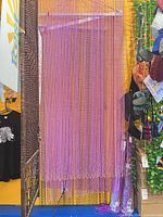 Full-length view of a purple beaded door curtain hanging in display, beads densely spaced