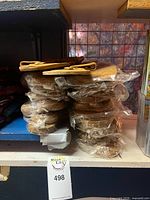 Stack of individually wrapped buffalo hide sandals pairs
