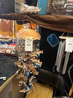 Full view of wind chime hanging, showing clay fish strands and dome cap