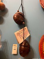 Two coconut shell purses hung to show size and strap style
