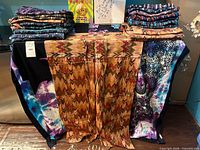 Stacks of folded patterned cotton pants on table