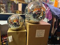 12-inch and 16-inch mirror disco balls on boxes