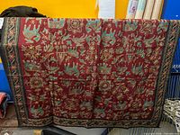 Full view of tapestry draped to show overall design and size